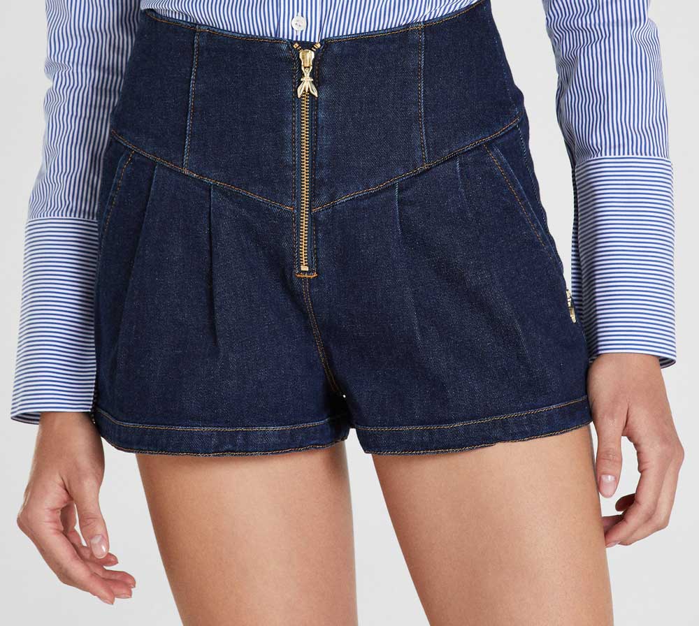 shorts denim con zip